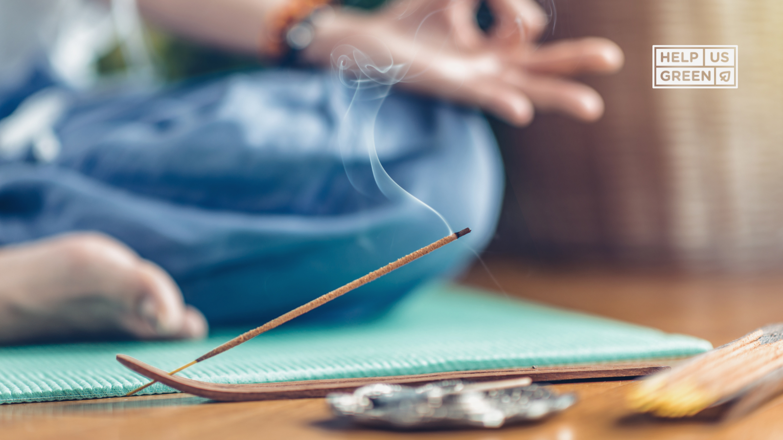 Person meditating peacefully beside lit agarbattis, with smoke gently rising—capturing a moment of calm and mindful spiritual practice.