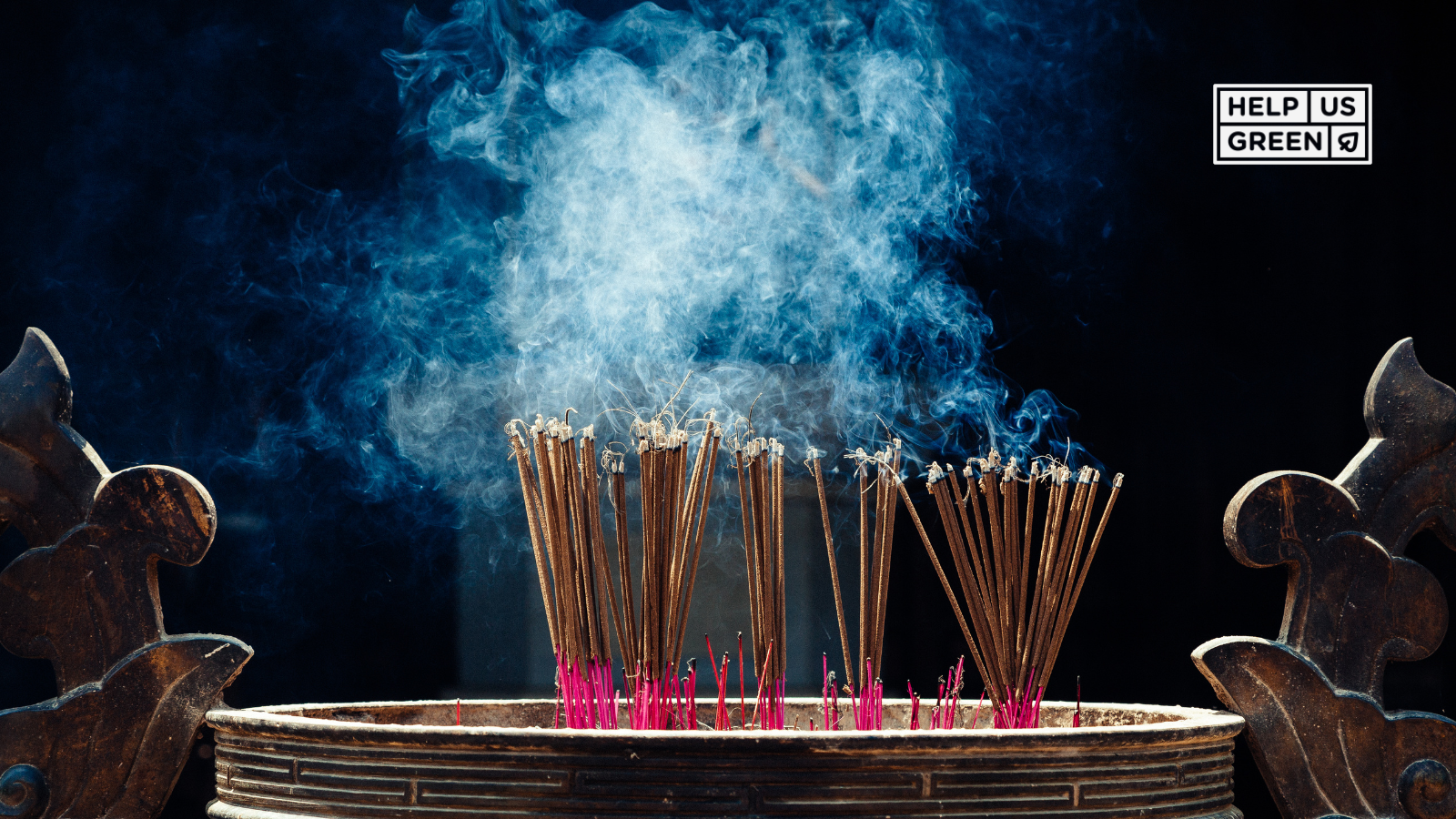 Multiple incense sticks burning together in a holder, with smoke swirling—representing devotion, cleansing, and ceremonial warmth.